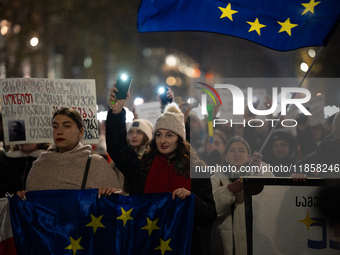 Georgia pro-Europe demonstrators hold Georgian and European flags during a protest against the Government's postponement of European Union a...