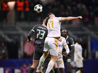 Francesco Camarda of AC Milan and Bruno Duarte of FK Crvena Zvezda battle for the ball during the UEFA Champions League match between AC Mil...