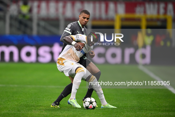 Cherif Ndiaye of FK Crvena Zvezda and Malick Thiaw of AC Milan battle for the ball during the UEFA Champions League match between AC Milan a...