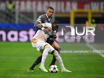 Cherif Ndiaye of FK Crvena Zvezda and Malick Thiaw of AC Milan battle for the ball during the UEFA Champions League match between AC Milan a...