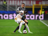 Cherif Ndiaye of FK Crvena Zvezda and Malick Thiaw of AC Milan battle for the ball during the UEFA Champions League match between AC Milan a...