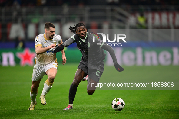 Ivan Gutesa of FK Crvena Zvezda and Rafael Leao of AC Milan battle for the ball during the UEFA Champions League match between AC Milan and...