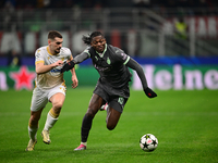 Ivan Gutesa of FK Crvena Zvezda and Rafael Leao of AC Milan battle for the ball during the UEFA Champions League match between AC Milan and...