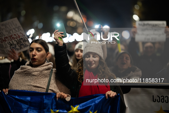 Georgia pro-Europe demonstrators hold Georgian and European flags during a protest against the Government's postponement of European Union a...