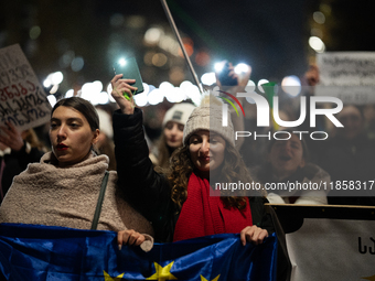 Georgia pro-Europe demonstrators hold Georgian and European flags during a protest against the Government's postponement of European Union a...