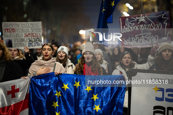 Georgia pro-Europe demonstrators hold Georgian and European flags during a protest against the Government's postponement of European Union a...