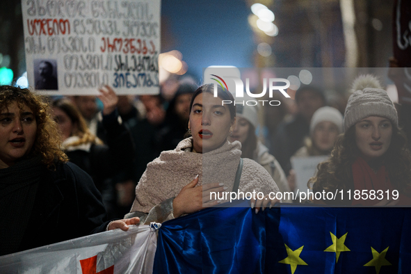 Georgia pro-Europe demonstrators hold Georgian and European flags during a protest against the Government's postponement of European Union a...