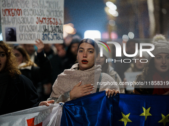 Georgia pro-Europe demonstrators hold Georgian and European flags during a protest against the Government's postponement of European Union a...