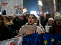 Georgia pro-Europe demonstrators hold Georgian and European flags during a protest against the Government's postponement of European Union a...