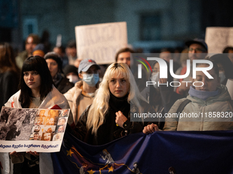 Protesters demonstrate against the government's postponement of European Union accession talks until 2028 outside the Parliament in central...