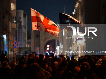 Georgia pro-Europe demonstrators hold Georgian and European flags during a protest against the Government's postponement of European Union a...