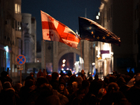 Georgia pro-Europe demonstrators hold Georgian and European flags during a protest against the Government's postponement of European Union a...