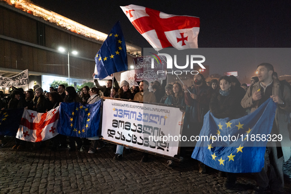 Georgia pro-Europe demonstrators hold Georgian and European flags during a protest against the Government's postponement of European Union a...