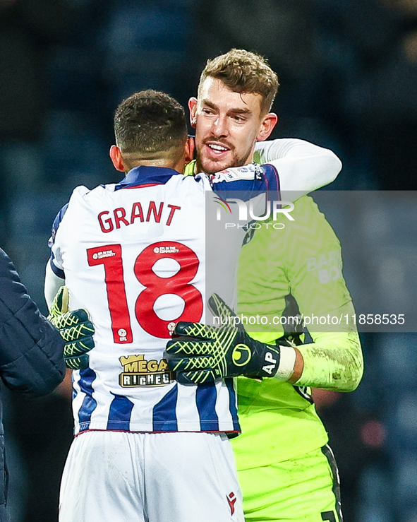 Number 18, Karlan Grant of WBA, is congratulated at full-time by number 1, goalkeeper Alex Palmer, during the Sky Bet Championship match bet...