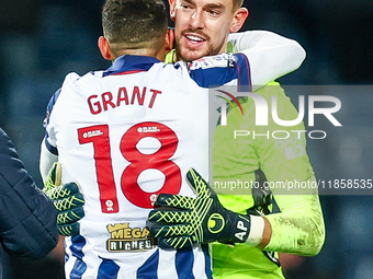 Number 18, Karlan Grant of WBA, is congratulated at full-time by number 1, goalkeeper Alex Palmer, during the Sky Bet Championship match bet...