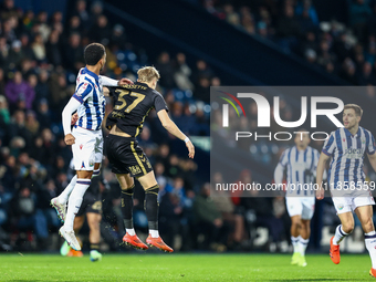 Mason Holgate of WBA and Norman Bassette of Coventry battle in the air during the Sky Bet Championship match between West Bromwich Albion an...