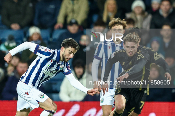 #22, Mikey Johnston of WBA, is in attacking action as #5, Jack Rudoni of Coventry, moves to intercept during the Sky Bet Championship match...