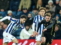 #22, Mikey Johnston of WBA, is in attacking action as #5, Jack Rudoni of Coventry, moves to intercept during the Sky Bet Championship match...