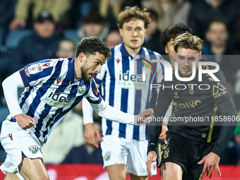 #22, Mikey Johnston of WBA, is in attacking action as #5, Jack Rudoni of Coventry, moves to intercept during the Sky Bet Championship match...