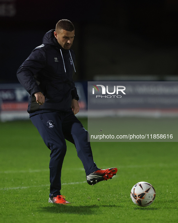 Hartlepool United strength and conditioning coach Carl Dickinson warms up during the The Isuzu FA Trophy Third Round match between Hartlepoo...