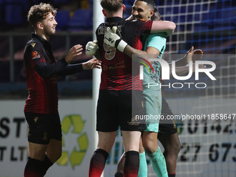 Tamworths' Jas Singh celebrates with Dan Creaney after they won a penalty shoot during the The Isuzu FA Trophy Third Round match between Har...