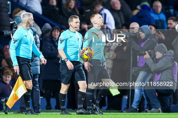 Referee, John Busby (centre) and assistants lead out the teams during the Sky Bet Championship match between West Bromwich Albion and Covent...