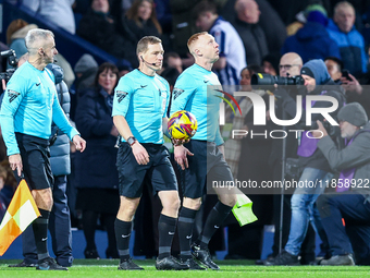 Referee, John Busby (centre) and assistants lead out the teams during the Sky Bet Championship match between West Bromwich Albion and Covent...