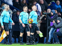 Referee, John Busby (centre) and assistants lead out the teams during the Sky Bet Championship match between West Bromwich Albion and Covent...