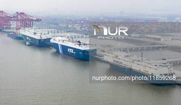 Cars are loaded and unloaded at a ro-ro vehicle terminal for export at Taicang Port area in Suzhou, East China's Jiangsu province, on Decemb...