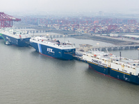 Cars are loaded and unloaded at a ro-ro vehicle terminal for export at Taicang Port area in Suzhou, East China's Jiangsu province, on Decemb...