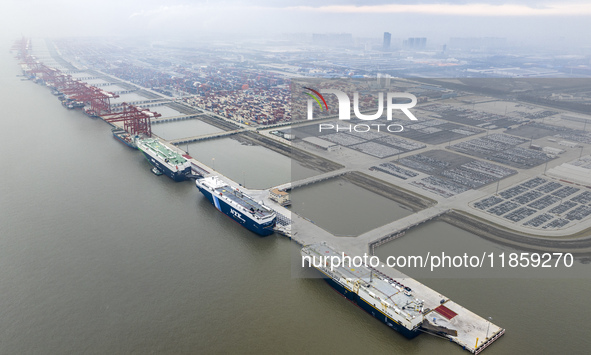 Cars are loaded and unloaded at a ro-ro vehicle terminal for export at Taicang Port area in Suzhou, East China's Jiangsu province, on Decemb...