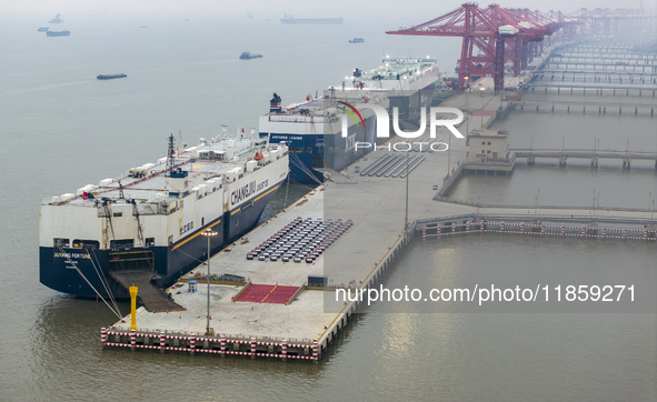 Cars are loaded and unloaded at a ro-ro vehicle terminal for export at Taicang Port area in Suzhou, East China's Jiangsu province, on Decemb...