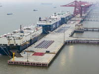 Cars are loaded and unloaded at a ro-ro vehicle terminal for export at Taicang Port area in Suzhou, East China's Jiangsu province, on Decemb...