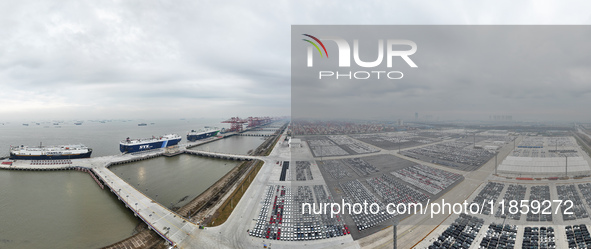 Cars are loaded and unloaded at a ro-ro vehicle terminal for export at Taicang Port area in Suzhou, East China's Jiangsu province, on Decemb...