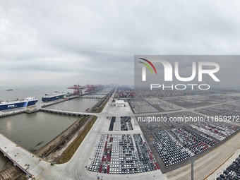 Cars are loaded and unloaded at a ro-ro vehicle terminal for export at Taicang Port area in Suzhou, East China's Jiangsu province, on Decemb...