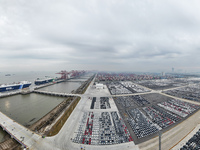 Cars are loaded and unloaded at a ro-ro vehicle terminal for export at Taicang Port area in Suzhou, East China's Jiangsu province, on Decemb...