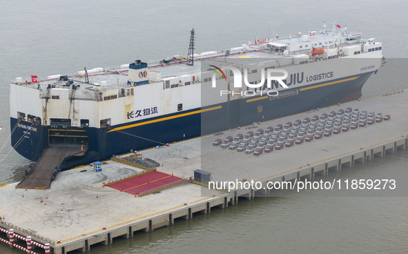 Cars are loaded and unloaded at a ro-ro vehicle terminal for export at Taicang Port area in Suzhou, East China's Jiangsu province, on Decemb...