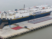 Cars are loaded and unloaded at a ro-ro vehicle terminal for export at Taicang Port area in Suzhou, East China's Jiangsu province, on Decemb...