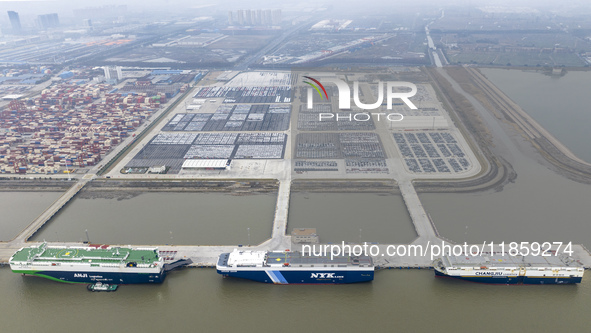 Cars are loaded and unloaded at a ro-ro vehicle terminal for export at Taicang Port area in Suzhou, East China's Jiangsu province, on Decemb...