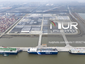 Cars are loaded and unloaded at a ro-ro vehicle terminal for export at Taicang Port area in Suzhou, East China's Jiangsu province, on Decemb...