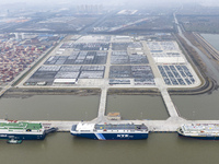 Cars are loaded and unloaded at a ro-ro vehicle terminal for export at Taicang Port area in Suzhou, East China's Jiangsu province, on Decemb...