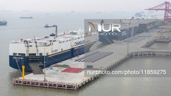 Cars are loaded and unloaded at a ro-ro vehicle terminal for export at Taicang Port area in Suzhou, East China's Jiangsu province, on Decemb...