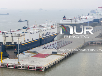 Cars are loaded and unloaded at a ro-ro vehicle terminal for export at Taicang Port area in Suzhou, East China's Jiangsu province, on Decemb...