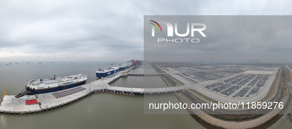 Cars are loaded and unloaded at a ro-ro vehicle terminal for export at Taicang Port area in Suzhou, East China's Jiangsu province, on Decemb...