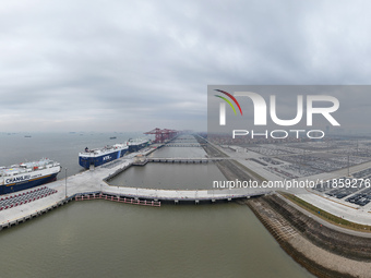 Cars are loaded and unloaded at a ro-ro vehicle terminal for export at Taicang Port area in Suzhou, East China's Jiangsu province, on Decemb...