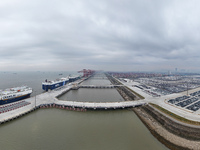 Cars are loaded and unloaded at a ro-ro vehicle terminal for export at Taicang Port area in Suzhou, East China's Jiangsu province, on Decemb...