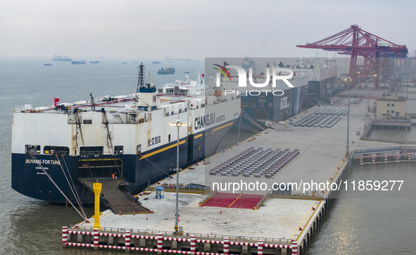 Cars are loaded and unloaded at a ro-ro vehicle terminal for export at Taicang Port area in Suzhou, East China's Jiangsu province, on Decemb...