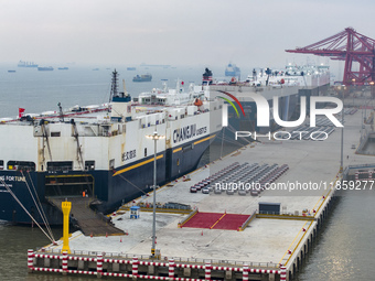 Cars are loaded and unloaded at a ro-ro vehicle terminal for export at Taicang Port area in Suzhou, East China's Jiangsu province, on Decemb...