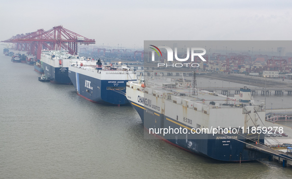 Cars are loaded and unloaded at a ro-ro vehicle terminal for export at Taicang Port area in Suzhou, East China's Jiangsu province, on Decemb...