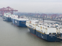 Cars are loaded and unloaded at a ro-ro vehicle terminal for export at Taicang Port area in Suzhou, East China's Jiangsu province, on Decemb...